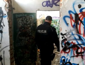 Zdjęcie policjantów kontrolujących pomieszczenie zgodnie z treścią informacji