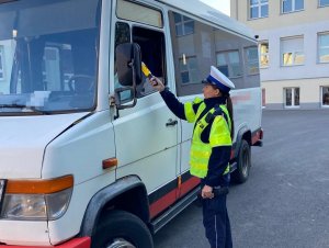 Policjant podczas kontroli autobusów szkolnych zgodnie z treścią komunikatu