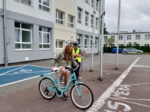 Policjanci podczas egzaminu na kartę rowerową na terenie szkoły